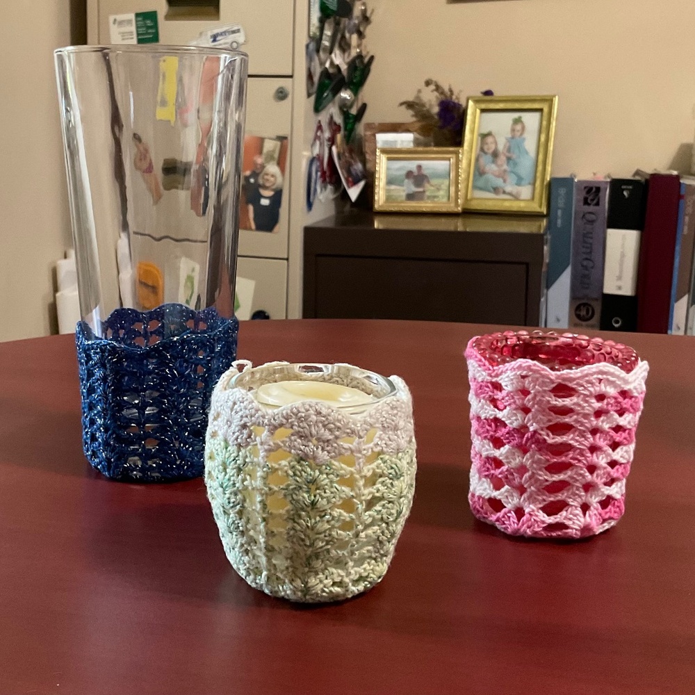 Handmade crocheted glass cozies also used as votive candle covers